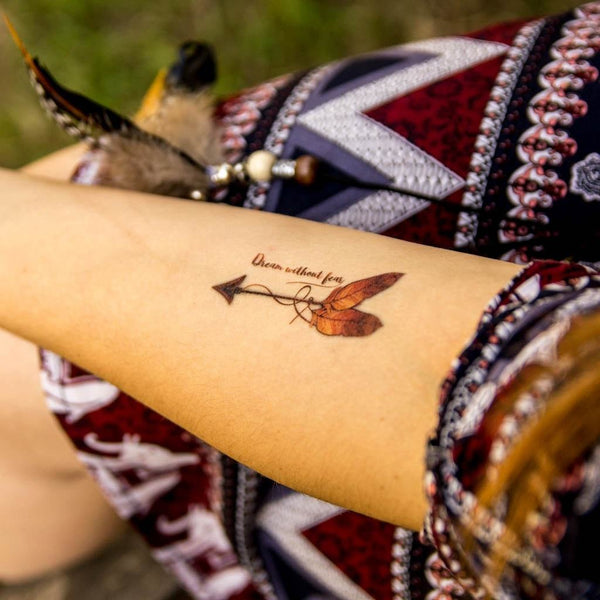 Woman in Indian Hair Dress with Bow and Arrow Tattoo